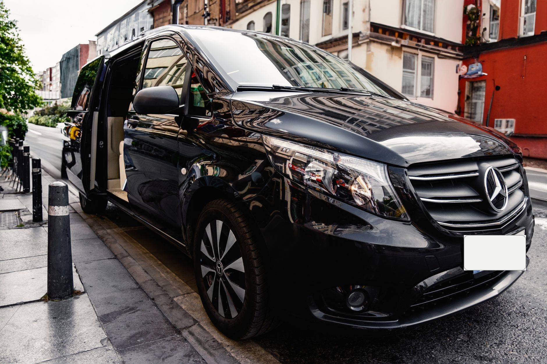 A stylish black Mercedes-Benz van parked on a bustling city street, showcasing luxury and modern design.